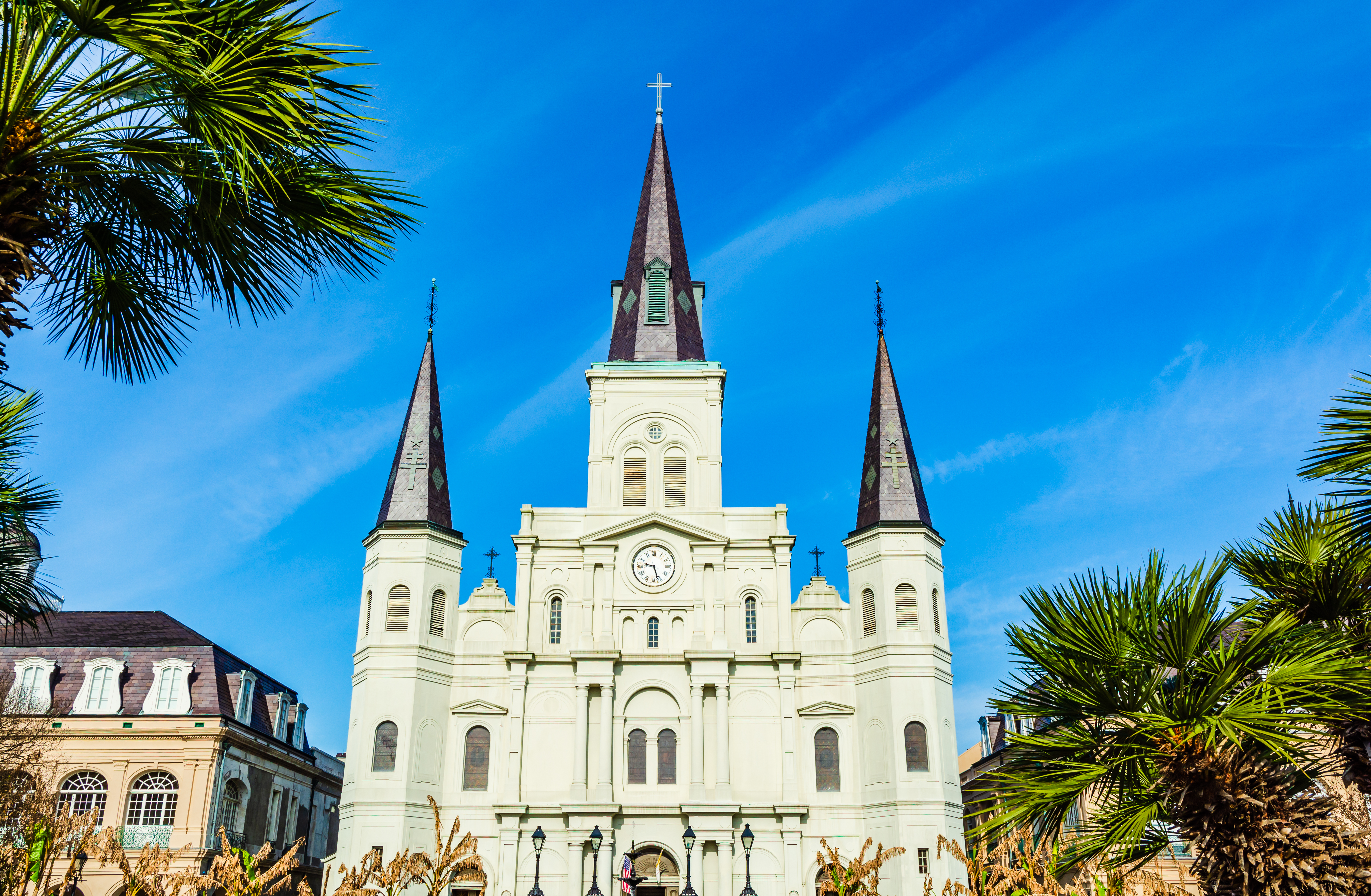 Historic stone church with a tall steeple against a clear sky